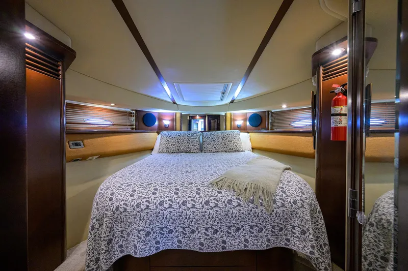 Yes Dear Yacht Photos Pics Luxurious 2005 Sea Ray 52 Sedan Bridge bedroom with elegant bedding and ambient lighting.