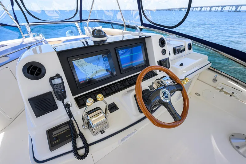 Yes Dear Yacht Photos Pics Helm of 2005 Sea Ray 52 Sedan Bridge with navigation screens and wooden steering wheel.