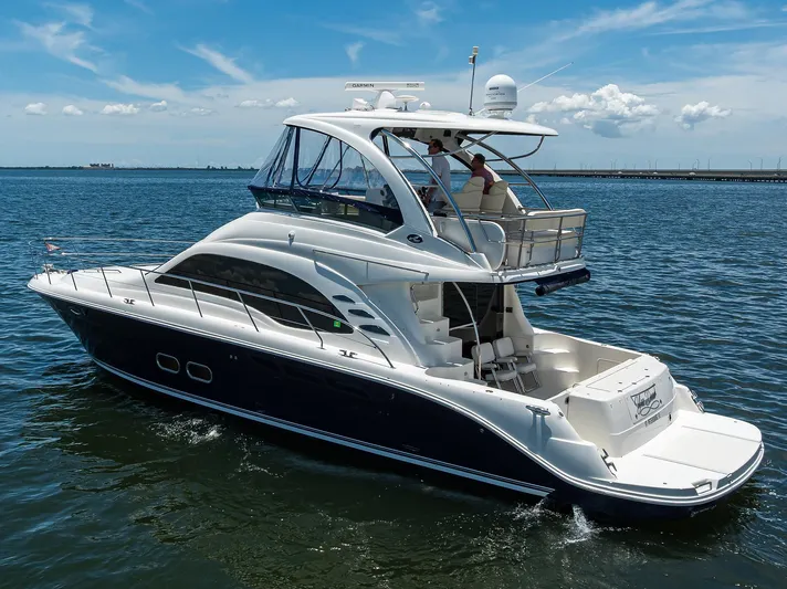 Yes Dear Yacht Photos Pics 2005 Sea Ray 52 Sedan Bridge yacht cruising on open water under a clear sky.