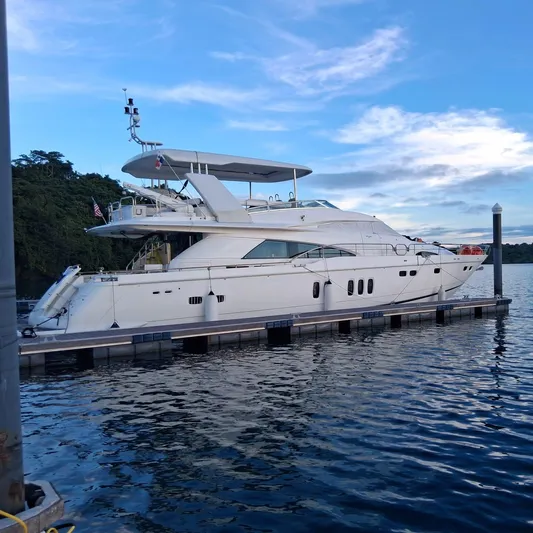  Yacht Photos Pics Luxury 2008 Fairline Squadron 74 yacht docked on calm water under blue sky.