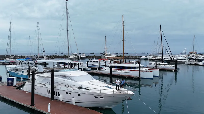  Yacht Photos Pics Luxury Fairline Squadron 74 yacht docked in a marina, surrounded by sailboats, 2008 model.