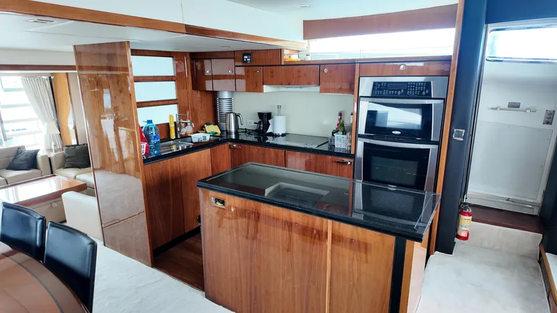  Yacht Photos Pics Luxurious kitchen interior of 2008 Fairline Squadron 74 yacht with modern appliances and wood finish.