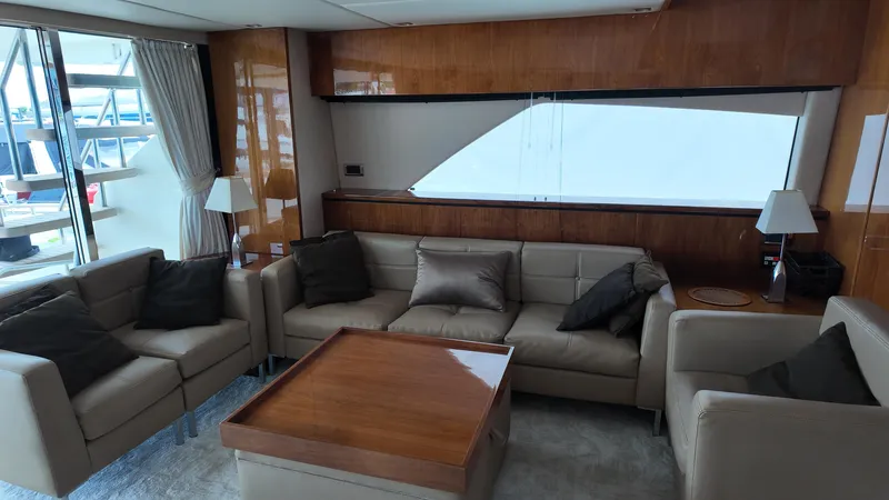  Yacht Photos Pics Luxurious interior of 2008 Fairline Squadron 74 yacht with elegant seating and wooden accents.