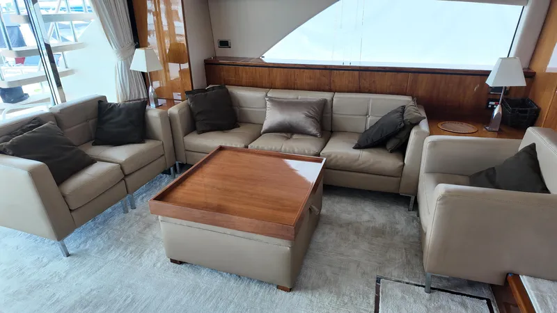  Yacht Photos Pics Luxurious interior of 2008 Fairline Squadron 74 yacht with beige leather seating and wooden table.