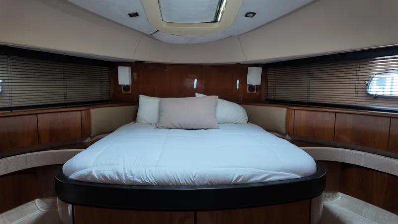  Yacht Photos Pics Luxurious cabin interior of 2008 Fairline Squadron 74 yacht with cozy bed and wooden accents.
