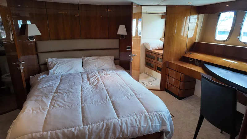 Yacht Photos Pics Luxurious cabin interior of 2008 Fairline Squadron 74 yacht with bed and wooden furnishings.