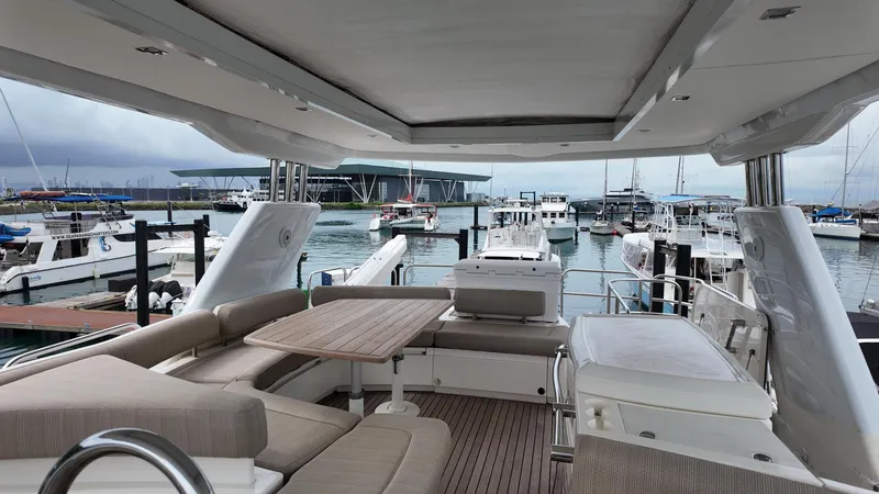  Yacht Photos Pics Luxurious 2008 Fairline Squadron 74 yacht interior at marina, featuring elegant seating and table.