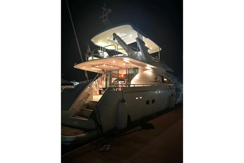  Yacht Photos Pics Luxury Fairline Squadron 74 yacht, 2008 model, illuminated at night, docked at a marina.