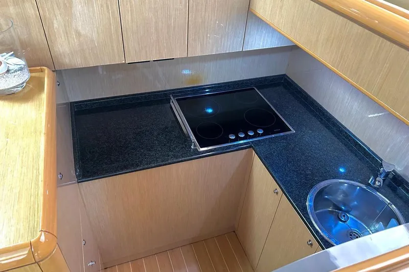  Yacht Photos Pics Modern kitchen in 2008 Fairline Squadron 74 yacht with sleek countertops and stove.