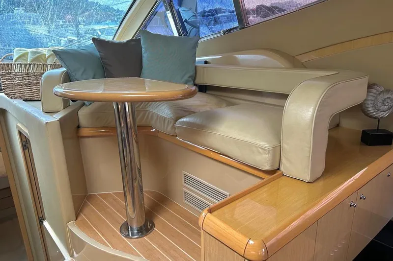  Yacht Photos Pics Luxurious interior of 2008 Fairline Squadron 74 yacht with leather seating and wooden table.