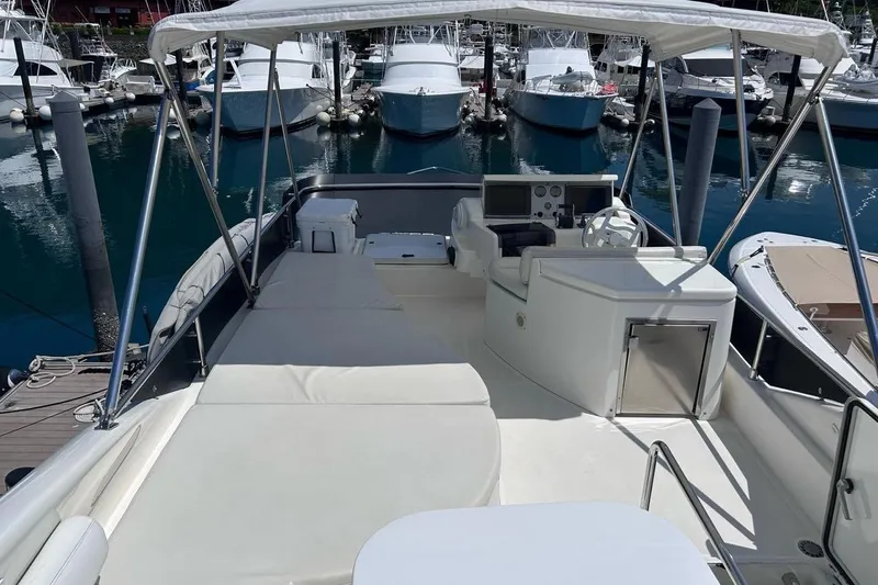  Yacht Photos Pics 2008 Fairline Squadron 74 yacht flybridge with helm, seating, and canopy in marina.