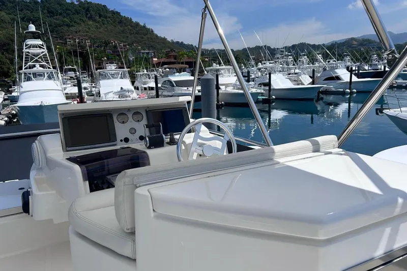  Yacht Photos Pics 2008 Fairline Squadron 74 yacht helm with marina view, featuring modern navigation equipment.