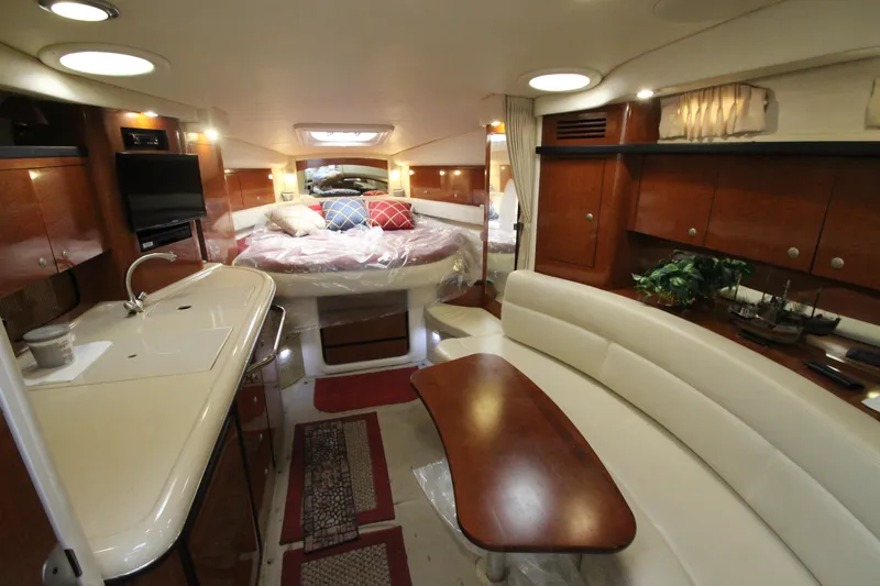  Yacht Photos Pics Luxurious interior of 2005 Sea Ray 340 Sundancer yacht with cozy seating and elegant wood finishes.
