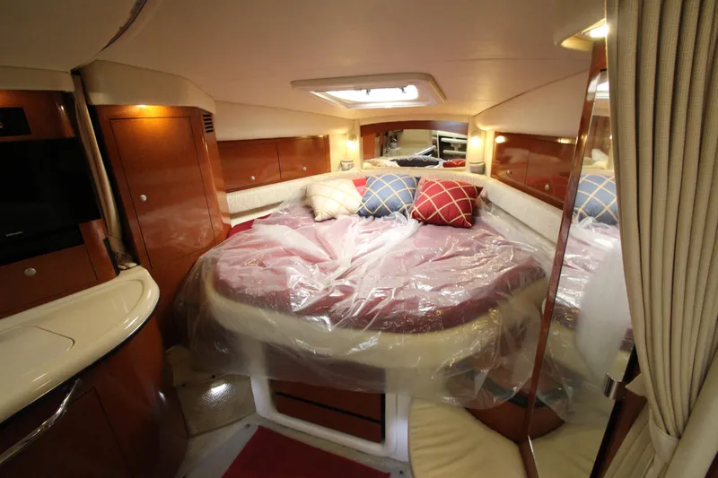  Yacht Photos Pics Interior of 2005 Sea Ray 340 Sundancer yacht with cozy bed and elegant wood finish.