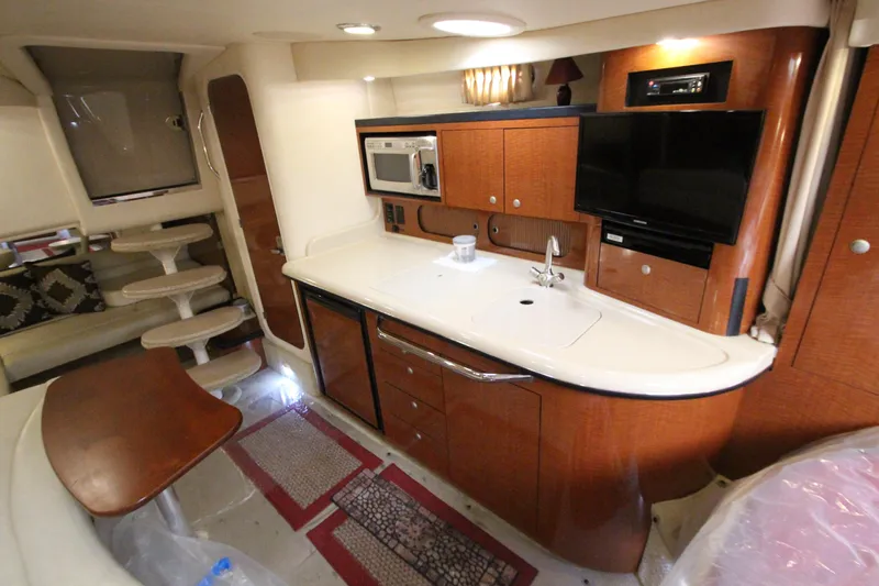  Yacht Photos Pics 2005 Sea Ray 340 Sundancer interior with kitchenette, TV, and seating area.
