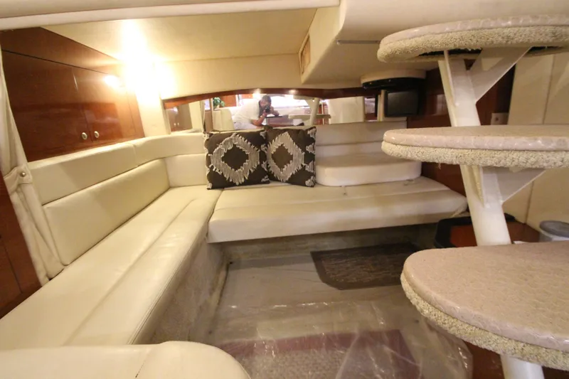  Yacht Photos Pics Interior of 2005 Sea Ray 340 Sundancer with beige seating and decorative pillows.