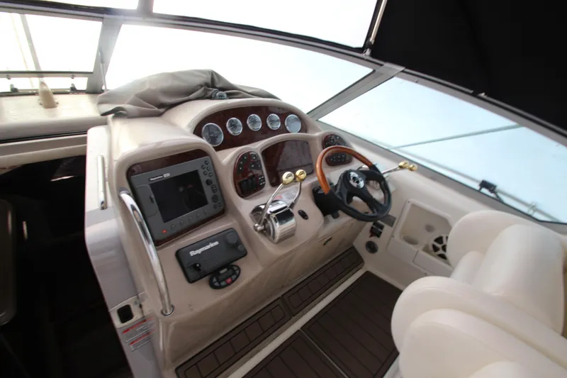  Yacht Photos Pics 2005 Sea Ray 340 Sundancer helm with gauges, steering wheel, and navigation equipment.