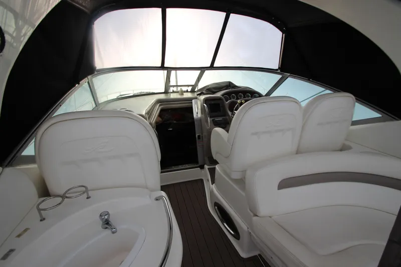  Yacht Photos Pics Interior of 2005 Sea Ray 340 Sundancer boat with white seating and helm controls.