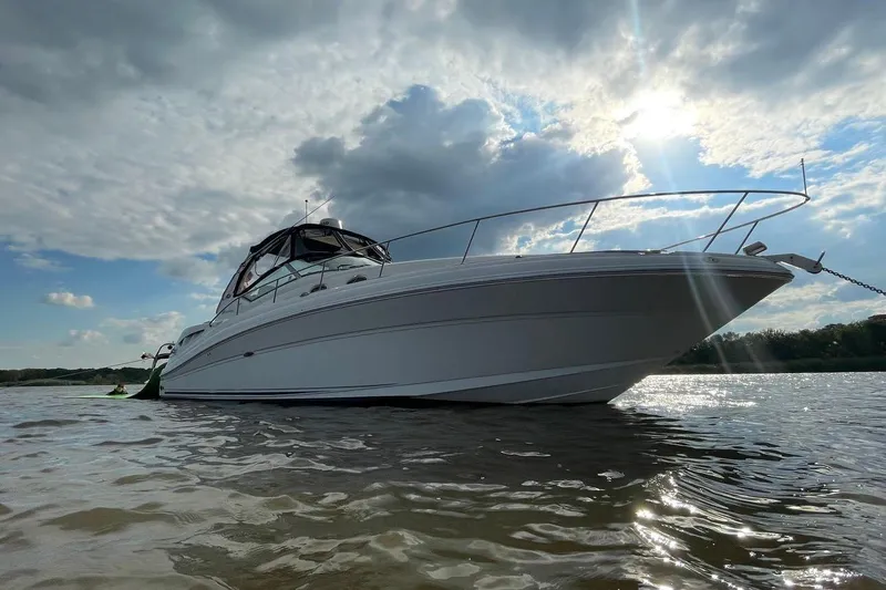  Yacht Photos Pics 2005 Sea Ray 340 Sundancer yacht anchored on a sunny day with cloudy skies.