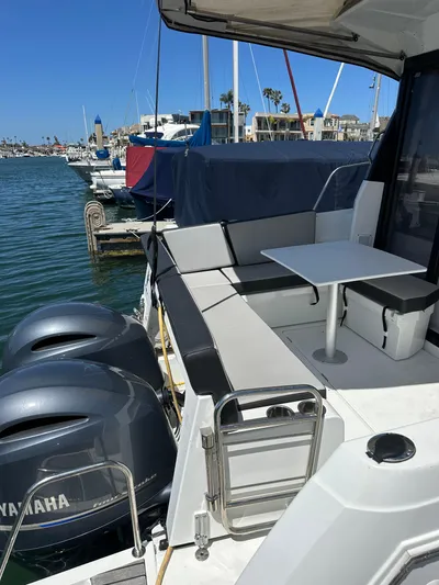 Destination Unknown II Yacht Photos Pics 2021 Jeanneau NC 895 boat with Yamaha engines docked at a marina.