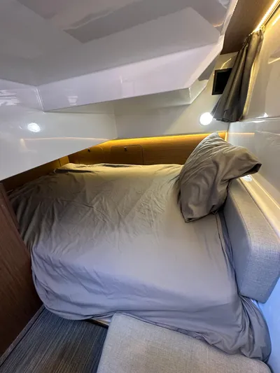 Destination Unknown II Yacht Photos Pics 2021 Jeanneau NC 895 cabin interior with cozy bed and modern design.