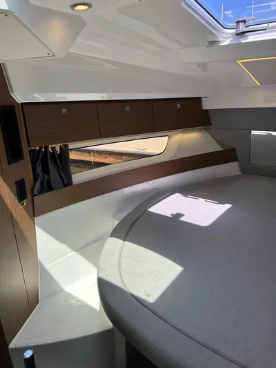 Destination Unknown II Yacht Photos Pics Interior of 2021 Jeanneau NC 895 boat with modern design and circular seating area.