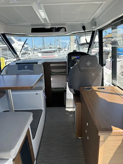 Destination Unknown II Yacht Photos Pics Interior of 2021 Jeanneau NC 895 boat with modern seating and helm.