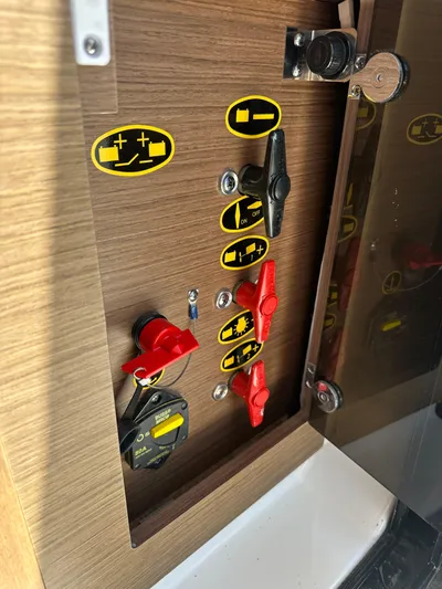 Destination Unknown II Yacht Photos Pics Control panel of a 2021 Jeanneau NC 895 boat with switches and indicators.