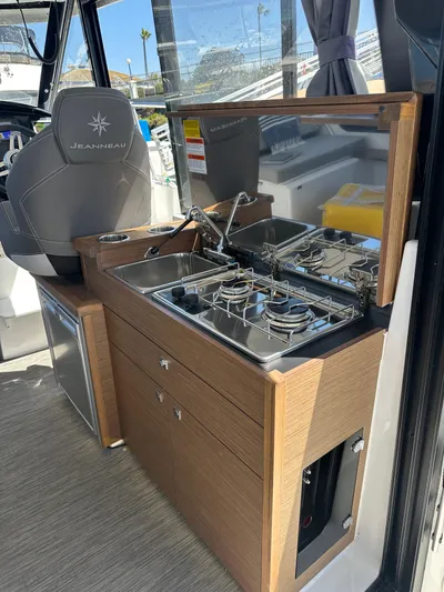 Destination Unknown II Yacht Photos Pics 2021 Jeanneau NC 895 boat interior with compact kitchen and modern amenities.