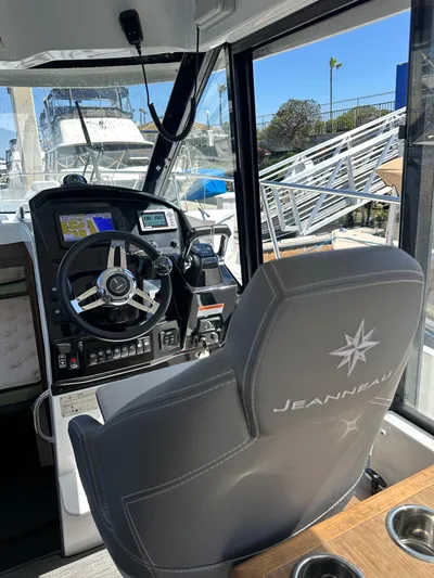 Destination Unknown II Yacht Photos Pics Interior of 2021 Jeanneau NC 895 boat with steering wheel and control panel.