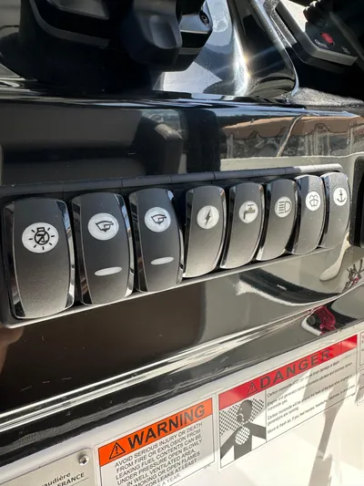 Destination Unknown II Yacht Photos Pics Control panel of 2021 Jeanneau NC 895 boat with labeled switches and warning labels.