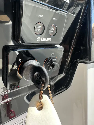 Destination Unknown II Yacht Photos Pics Yamaha ignition system on 2021 Jeanneau NC 895 boat dashboard with start/stop buttons.