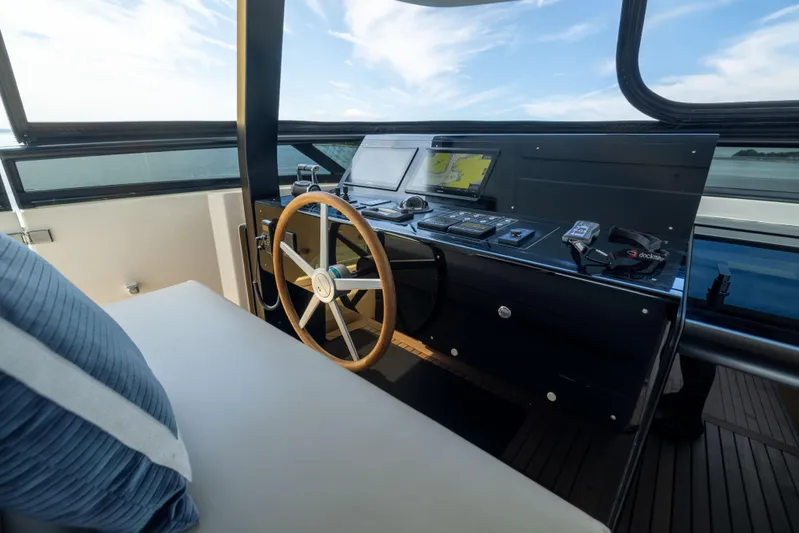 Sori San Lorenzo Yacht Photos Pics Helm of 2024 Sanlorenzo SL90A yacht with modern navigation equipment and wooden steering wheel.