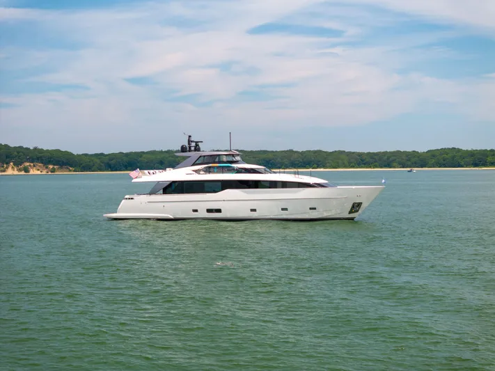 Sori San Lorenzo Yacht Photos Pics 2024 Sanlorenzo SL90A yacht cruising on a serene lake under a clear sky.