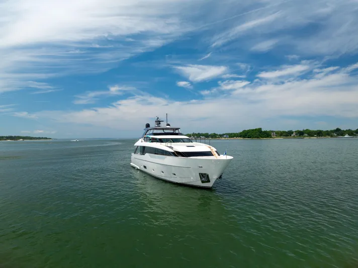Sori San Lorenzo Yacht Photos Pics 2024 Sanlorenzo SL90A yacht cruising on a serene waterway under a clear blue sky.