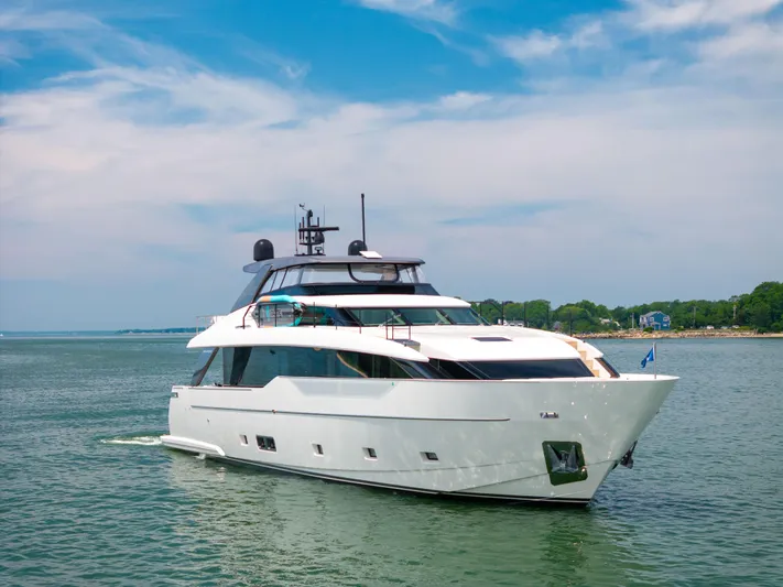 Sori San Lorenzo Yacht Photos Pics 2024 Sanlorenzo SL90A yacht cruising on a serene waterway under a clear blue sky.