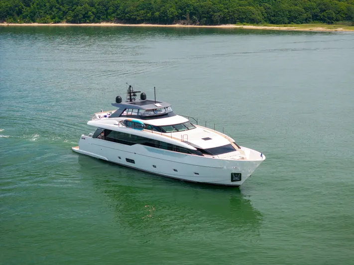 Sori San Lorenzo Yacht Photos Pics 2024 Sanlorenzo SL90A yacht cruising on calm waters near a lush shoreline.