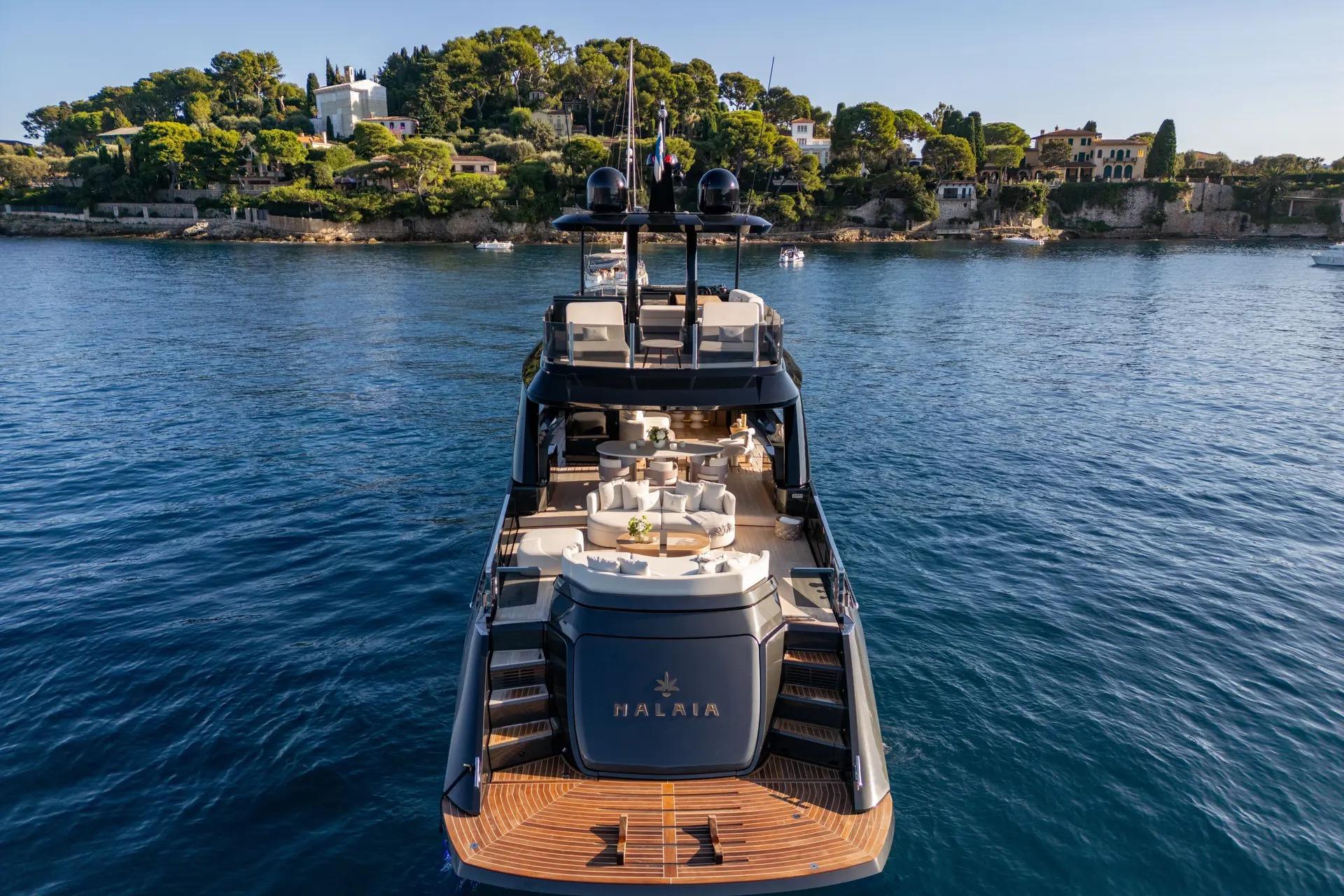 Luxurious 2025 Explorer 62 yacht on serene waters, with scenic coastal backdrop.