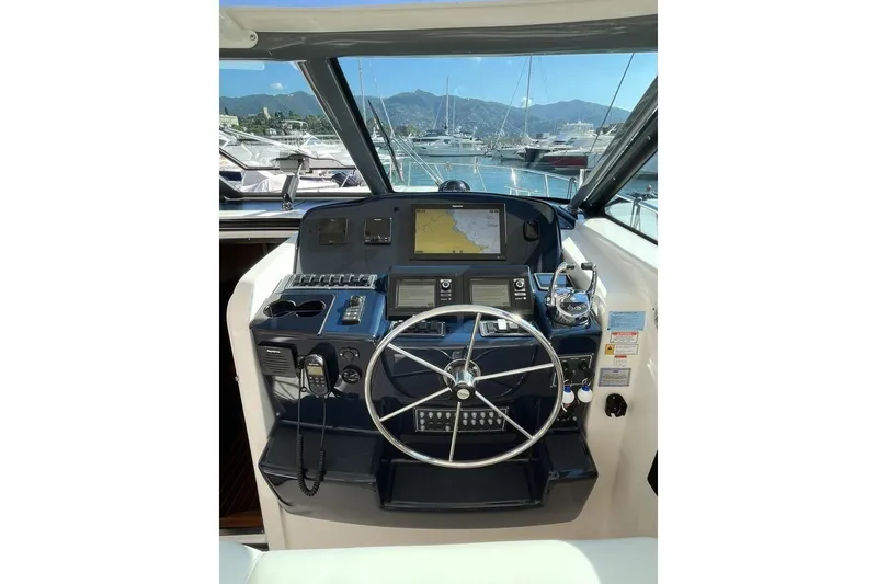  Yacht Photos Pics Helm of 2004 Tiara Yachts 4200 Open with navigation equipment and steering wheel.