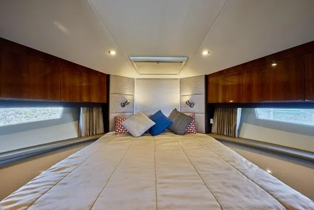  Yacht Photos Pics Luxurious bedroom interior of 2015 Carver C34 Command Bridge yacht with elegant bedding and wood accents.