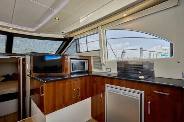  Yacht Photos Pics Interior of 2015 Carver C34 Command Bridge yacht with modern kitchen amenities.