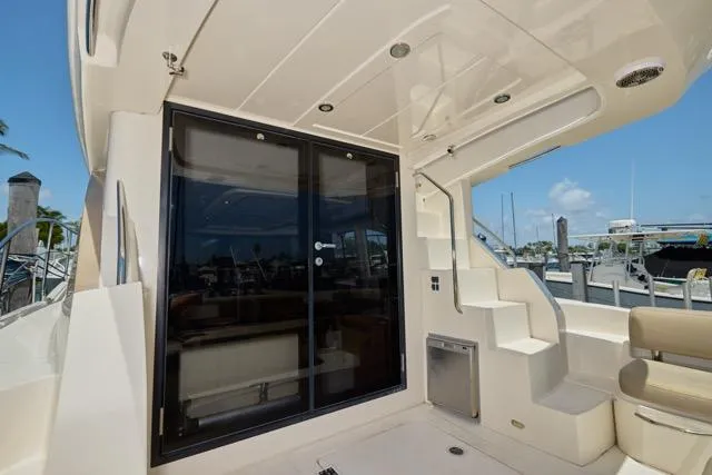  Yacht Photos Pics 2015 Carver C34 Command Bridge yacht with sliding glass doors and outdoor seating area.