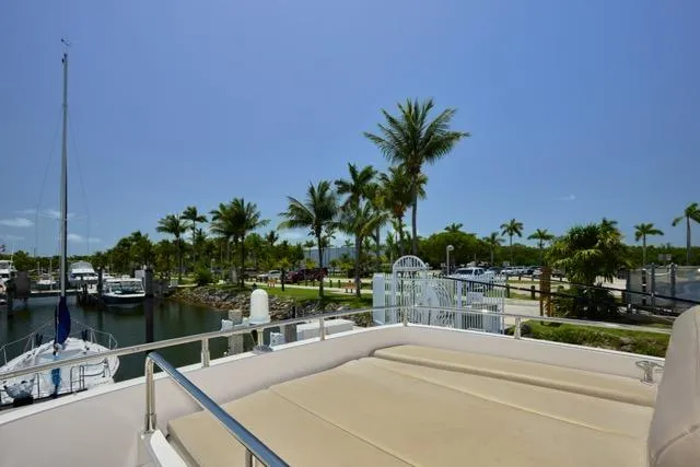  Yacht Photos Pics 2015 Carver C34 Command Bridge yacht docked near palm trees and marina.