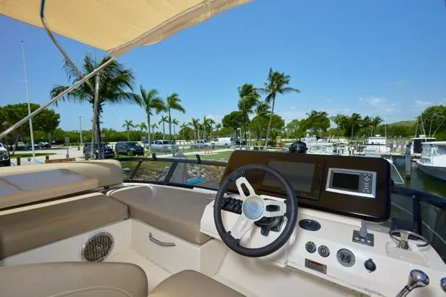  Yacht Photos Pics 2015 Carver C34 Command Bridge helm with palm trees and marina view.