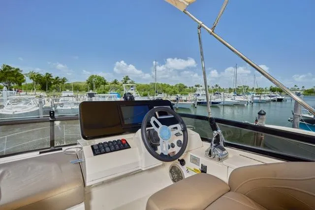  Yacht Photos Pics 2015 Carver C34 Command Bridge helm with marina view, featuring modern controls and comfortable seating.