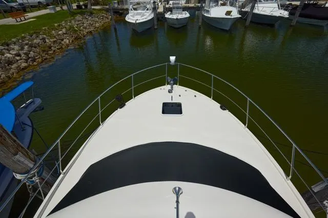  Yacht Photos Pics Bow view of 2015 Carver C34 Command Bridge docked in a marina.