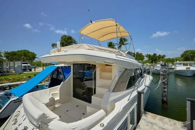  Yacht Photos Pics 2015 Carver C34 Command Bridge yacht docked, featuring spacious deck and canopy under clear skies.
