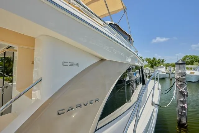  Yacht Photos Pics 2015 Carver C34 Command Bridge yacht docked at marina under clear blue sky.