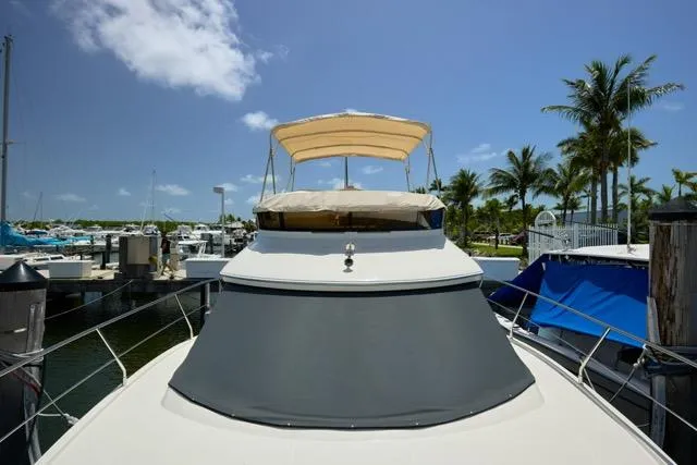  Yacht Photos Pics 2015 Carver C34 Command Bridge yacht docked at a marina under a clear blue sky.