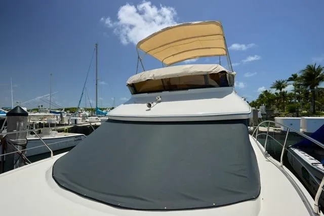  Yacht Photos Pics 2015 Carver C34 Command Bridge yacht docked under clear blue sky.